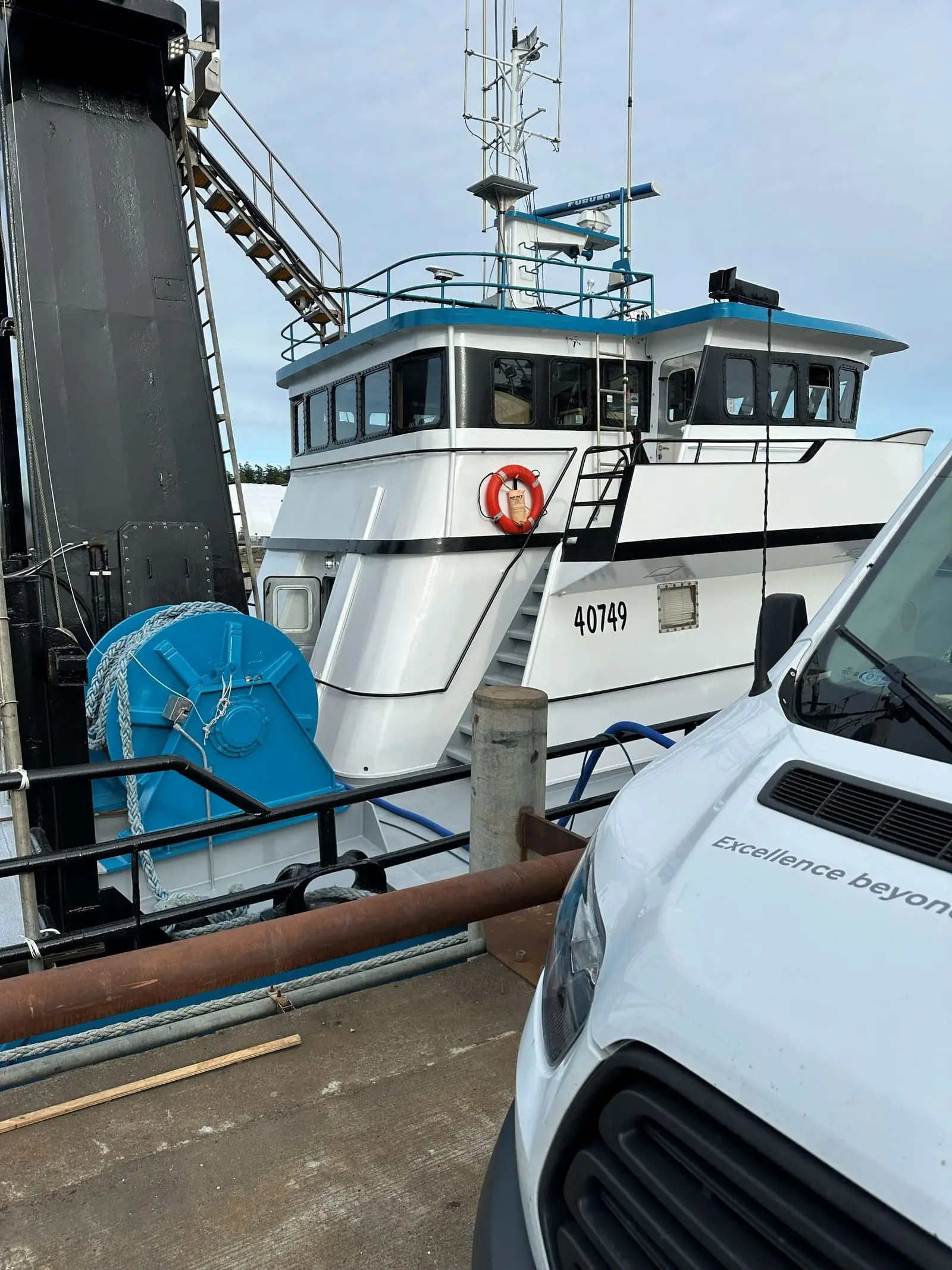 The A Clean Carpet Co van parked alongside a commercial fishing vessel at the Anacortes waterfront