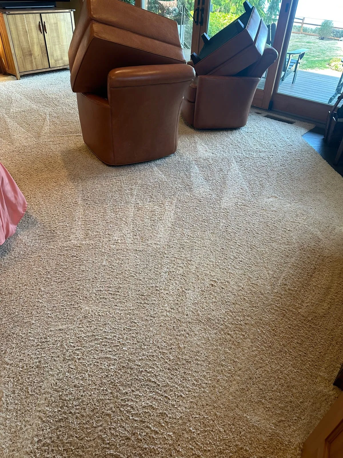 Plush cream bedroom carpet in a Langley home just after cleaning, with leather swivel chairs tipped up out of the way near the patio doors